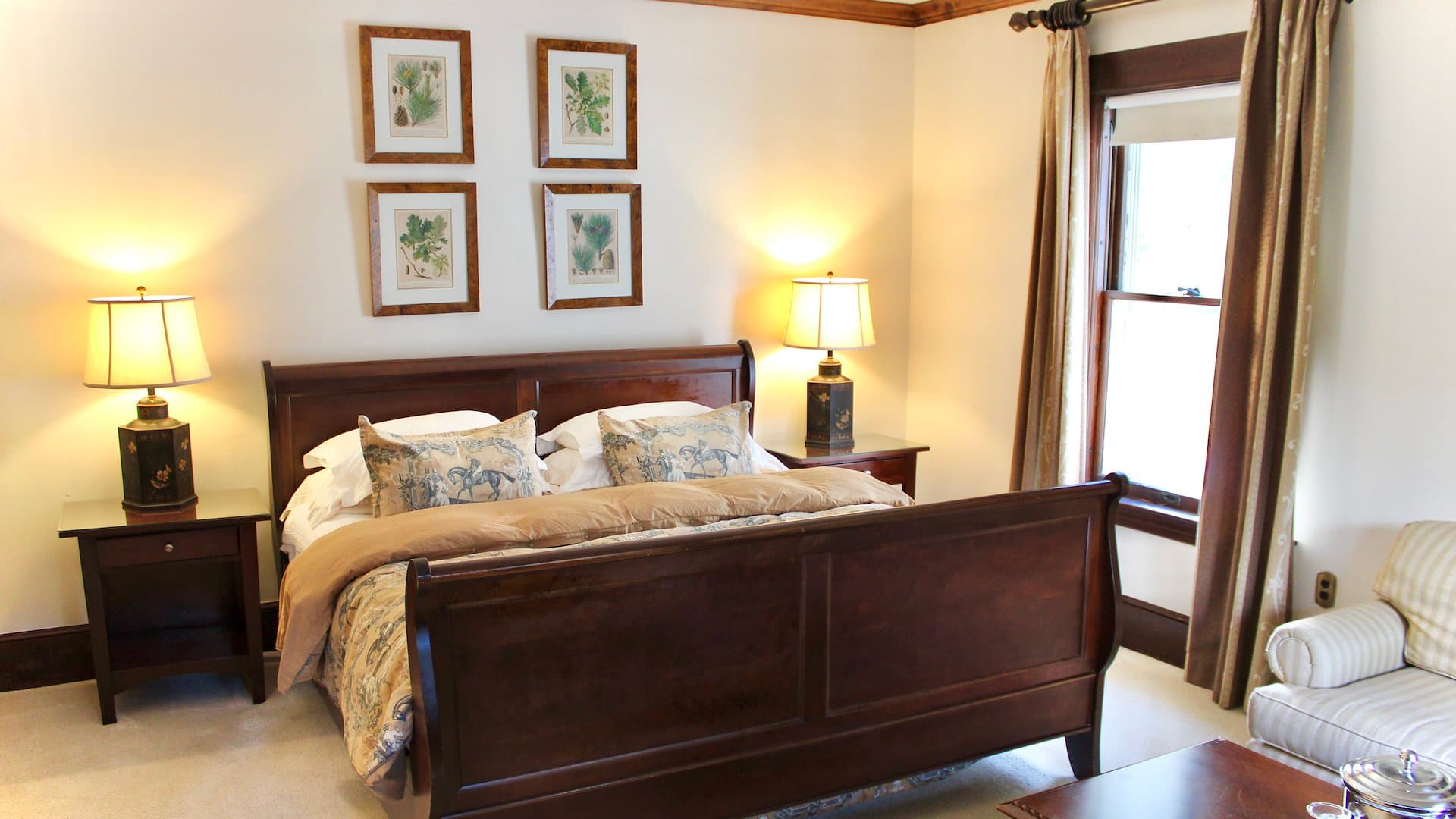 A cozy bedroom featuring a wooden bed, two bedside lamps, and decorative wall art.